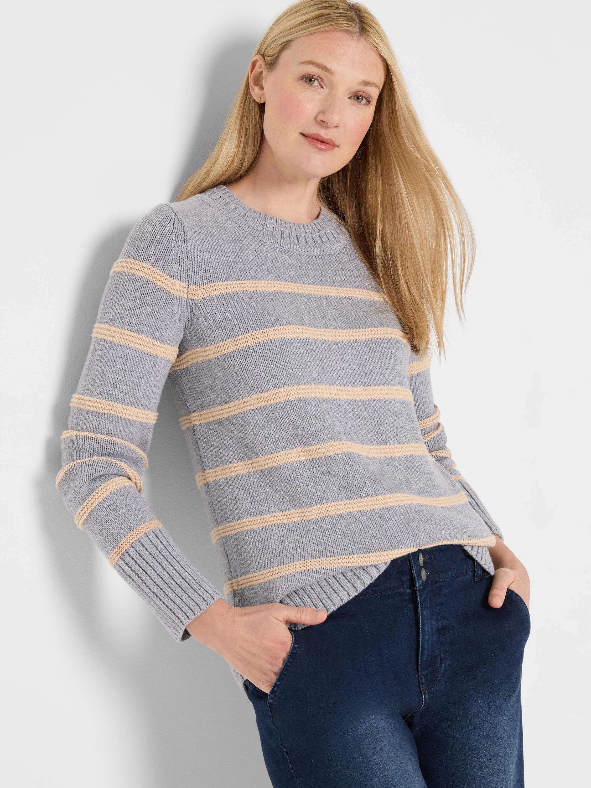 Pale blue-grey crewneck sweater with horizontal cream stripes, featuring ribbed cuffs and hem.