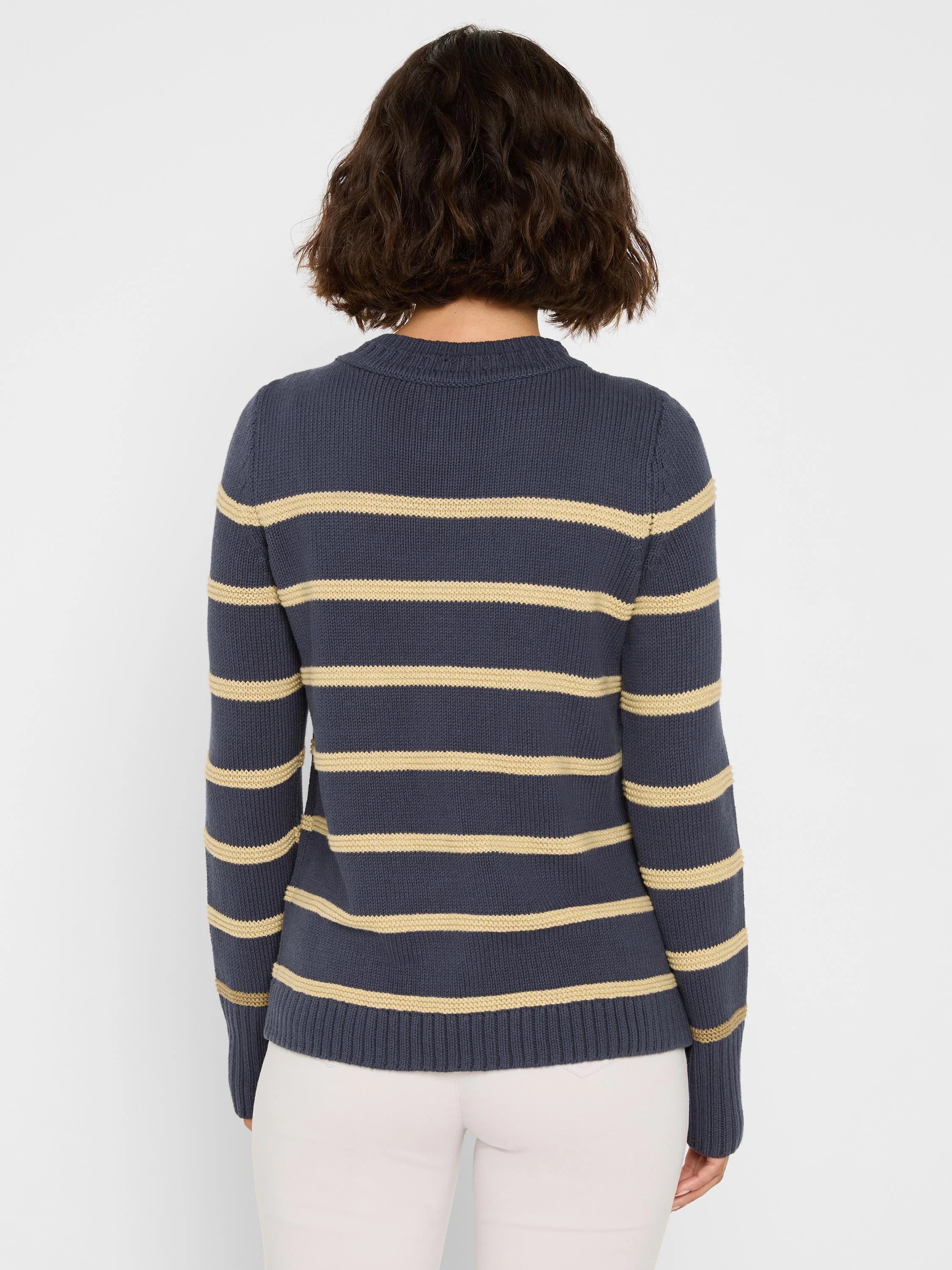Back of a navy knit sweater with horizontal tan stripes.