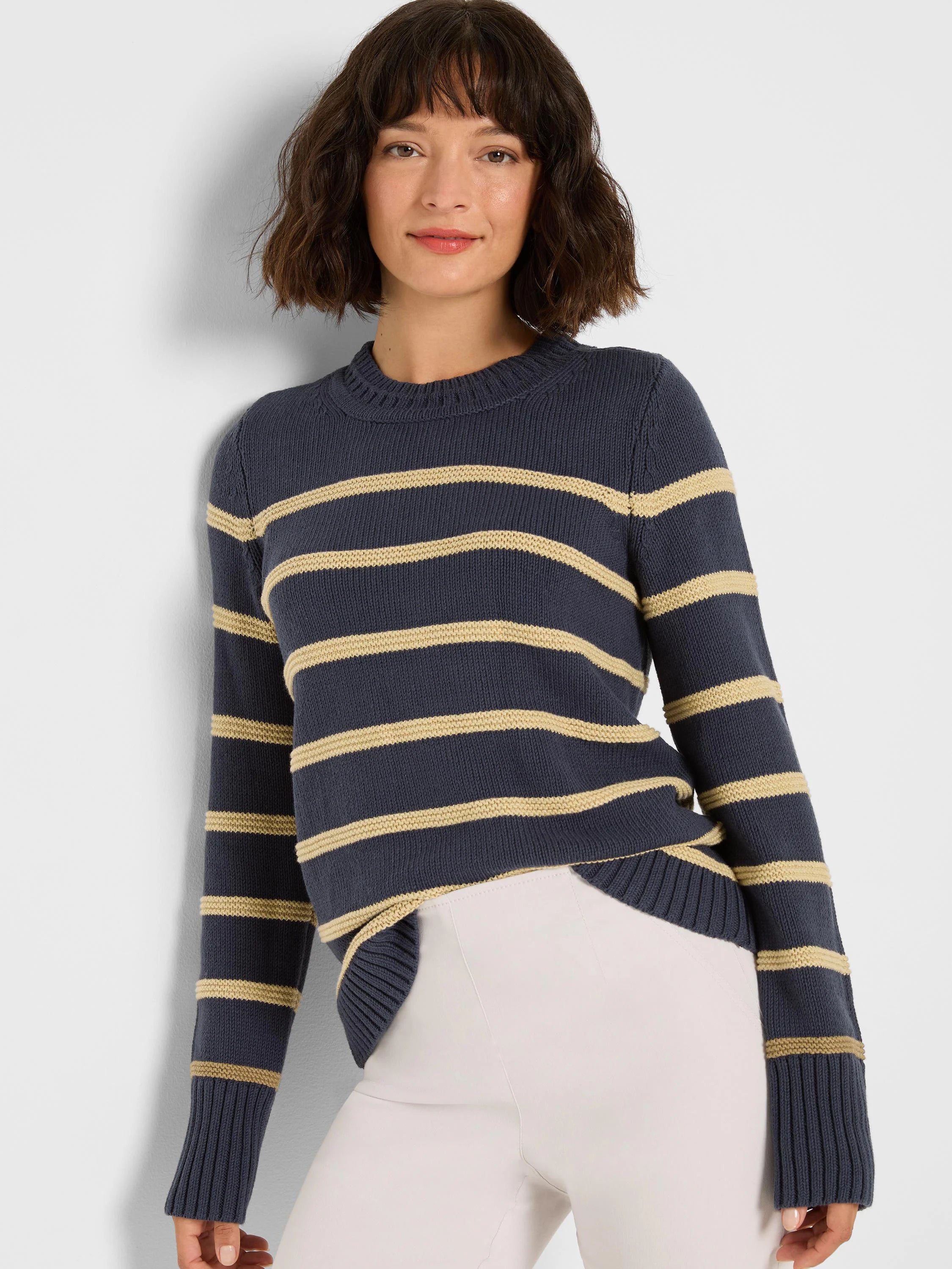 Navy blue crew neck sweater with tan horizontal stripes and ribbed cuffs.