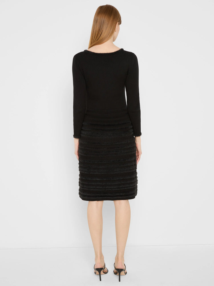 Black long-sleeved dress with ribbed knit top. Skirt features horizontal tiers of soft, fuzzy texture. Fuzzy trim on...
