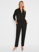 Black 28" Ponte Knit Trousers. Tailored, slim-fit, ankle-length pants on a model.