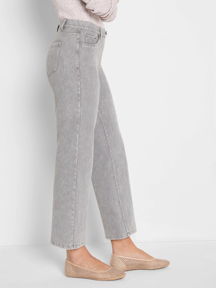 Light grey washed straight-leg knit ankle jeans, shown on a person, featuring front and back pockets.
