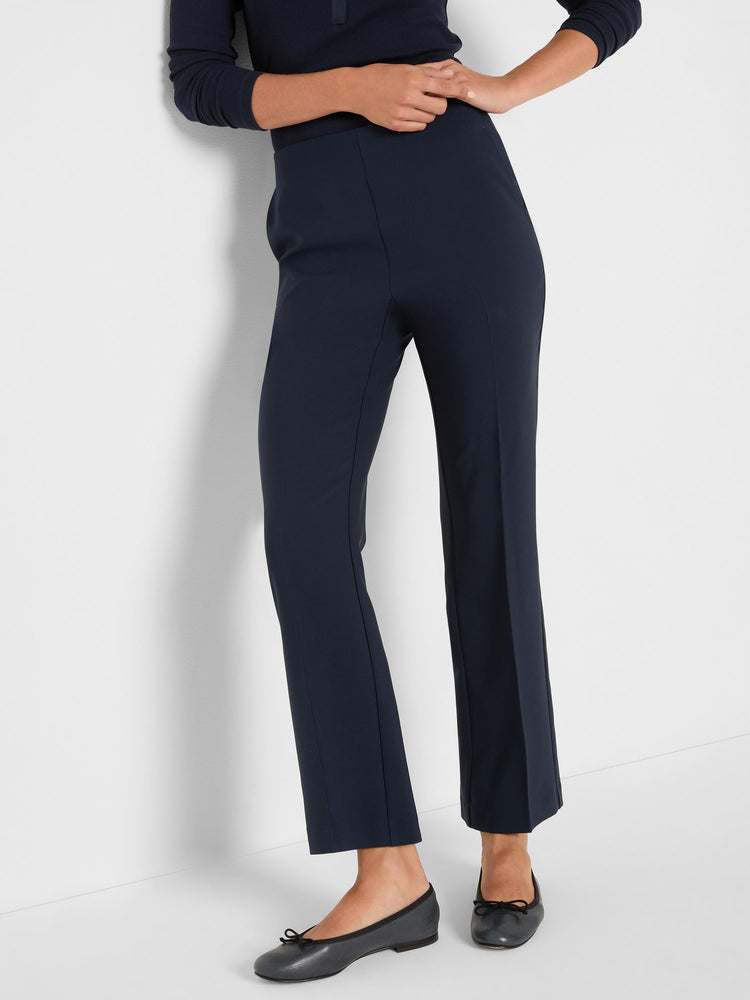 Navy blue high-waisted trousers with a cropped length, subtle straight leg, and distinctive front seam detailing.