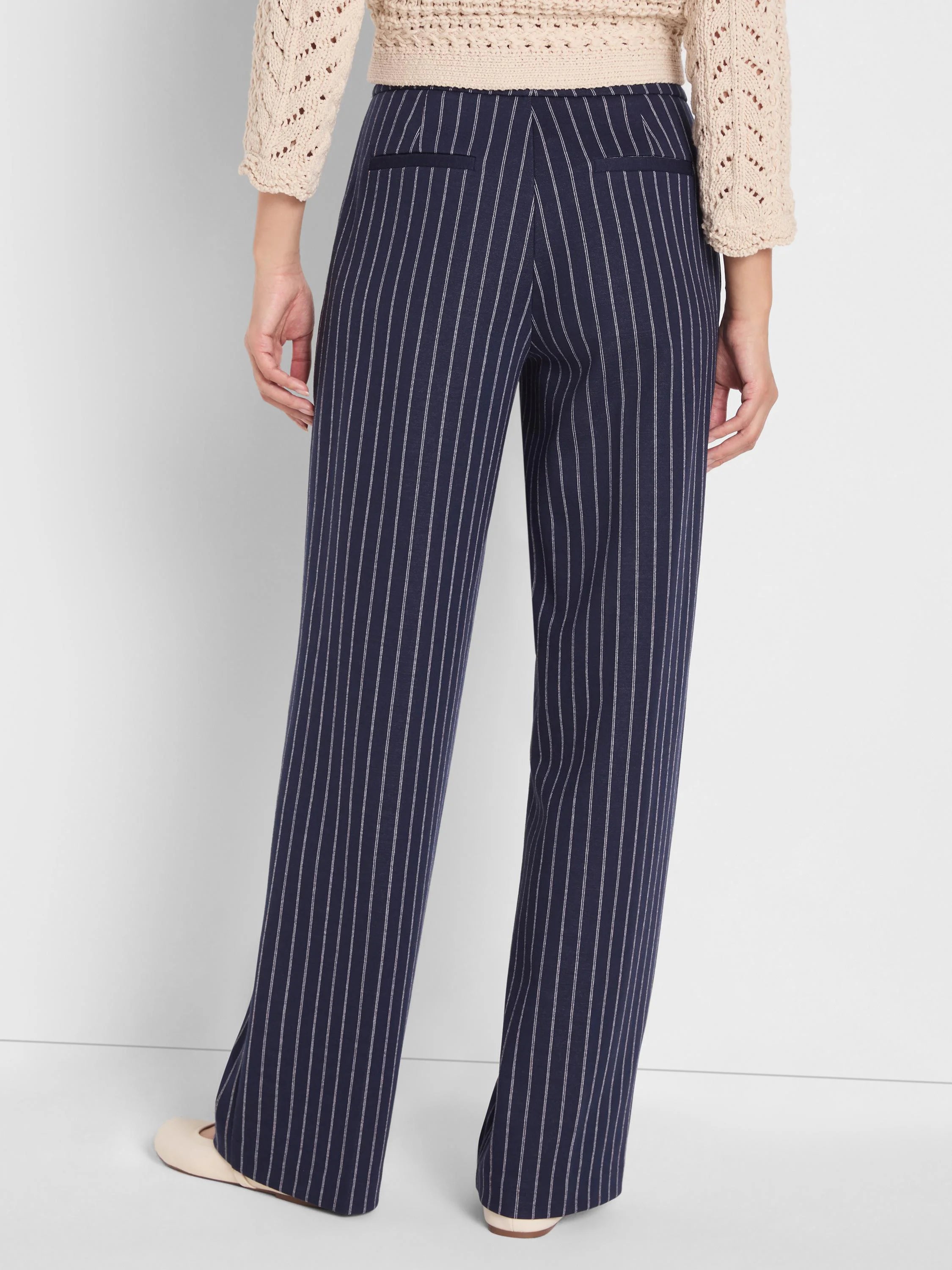 Navy knit wide leg pants with thin white pinstripes, shown from behind. Features rear pockets.
