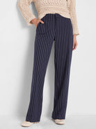 Navy wide-leg knit pants with fine white pinstripes, featuring slip pockets.