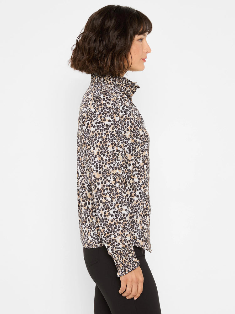Cream, brown, & black leopard print top. Features a ruffled mock neck and smocked cuffs.