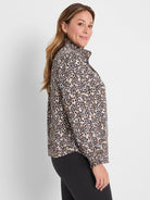 Long-sleeve leopard print top in dark brown, tan, and off-white, with a ruffled mock neck and elasticized cuffs.