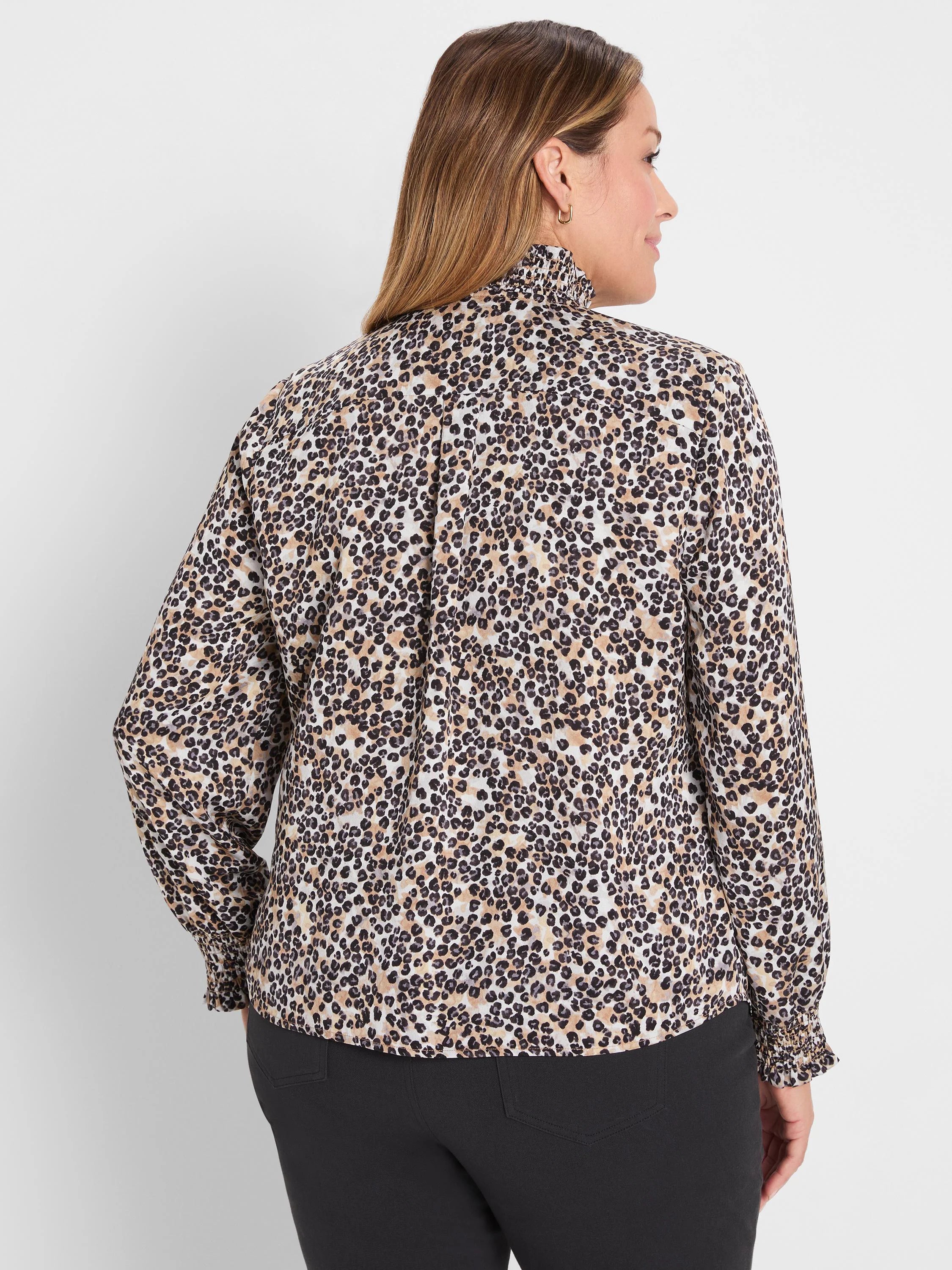 Cream, tan & black leopard print top with a ruffled high collar and gathered long sleeves, seen from behind.