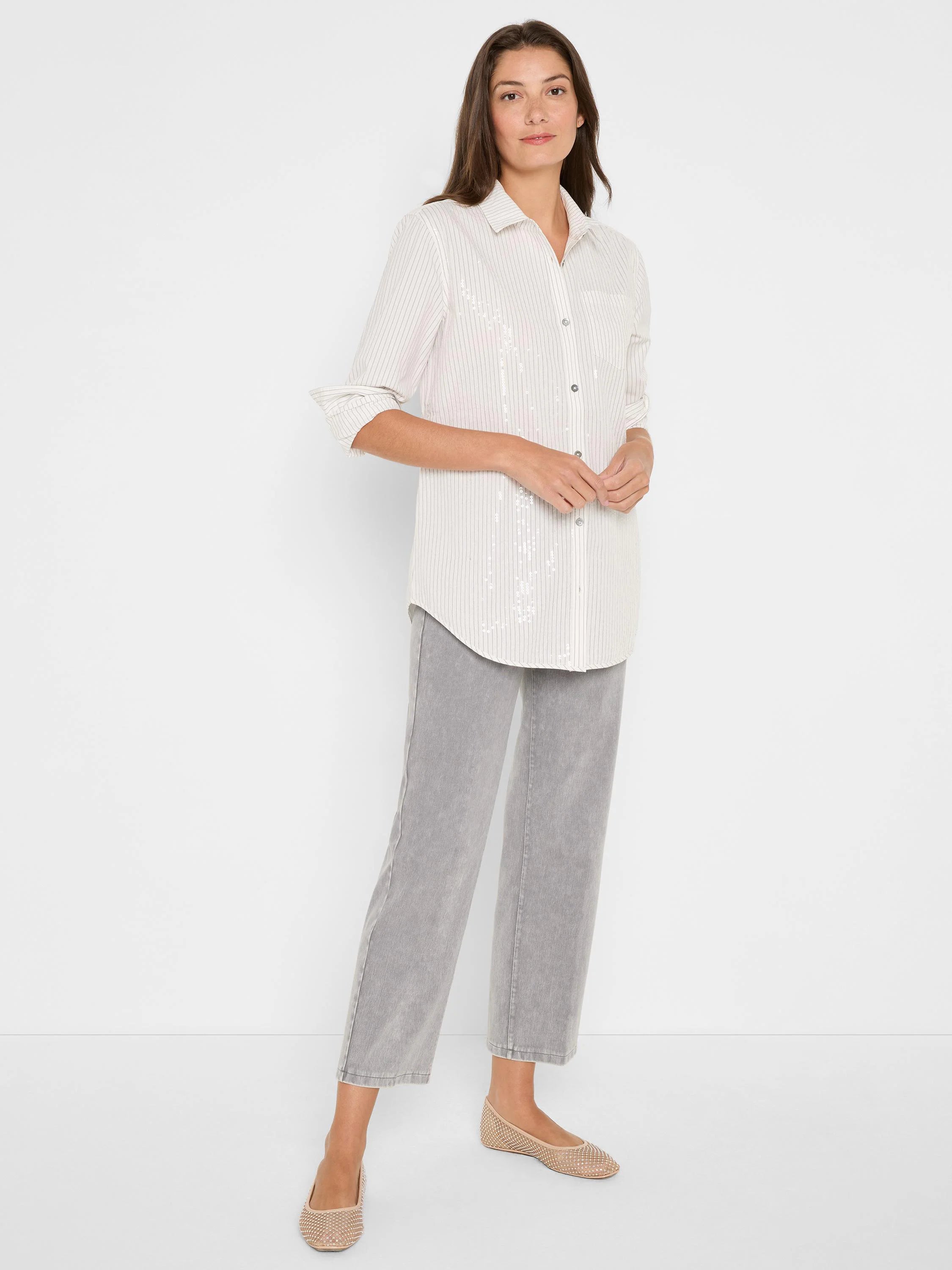 Cream button-up shirt with thin gray vertical stripes & scattered subtle sequins. Long sleeves are rolled.