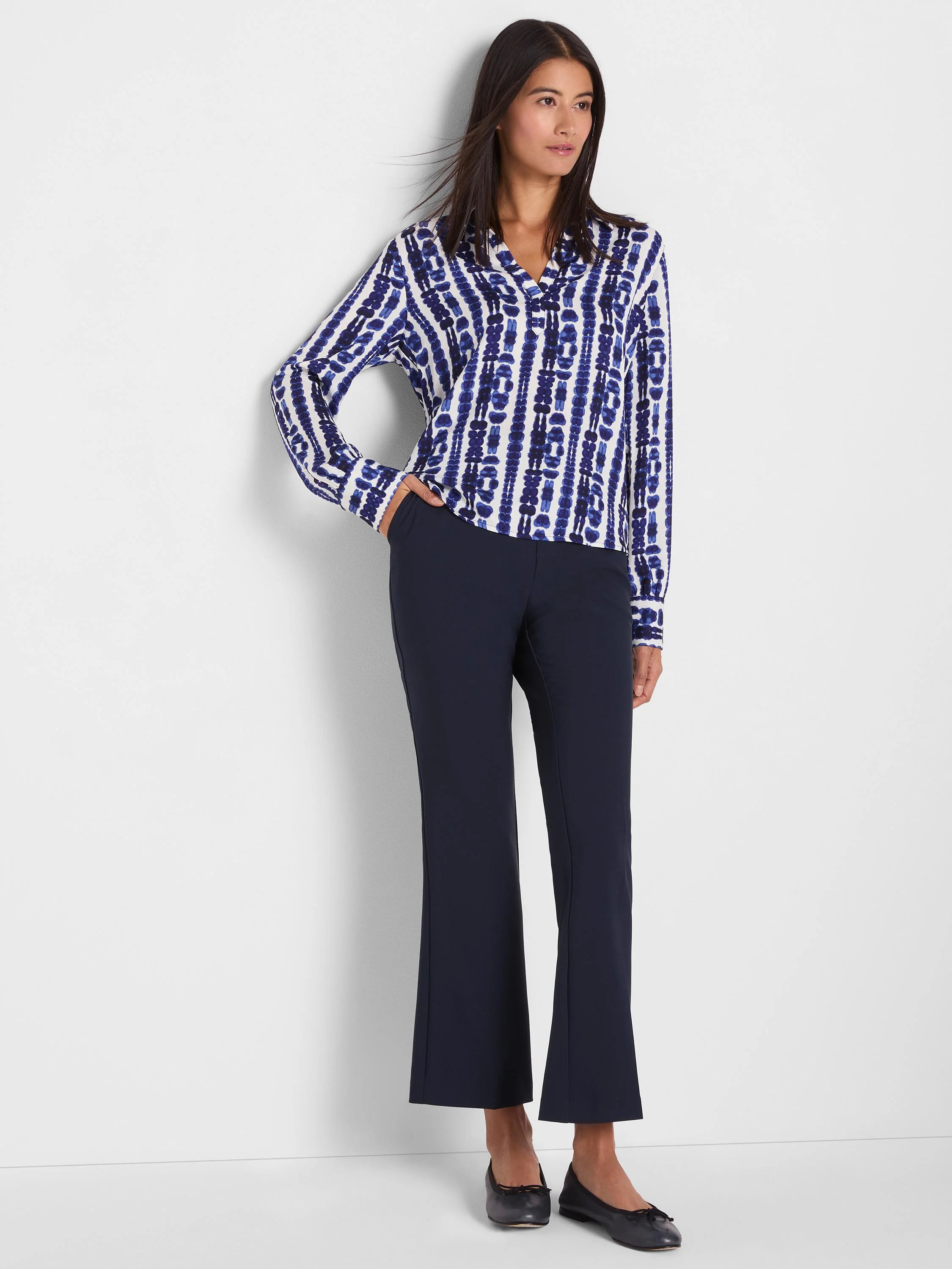 White long-sleeved top with an indigo blue shibori stripe pattern.