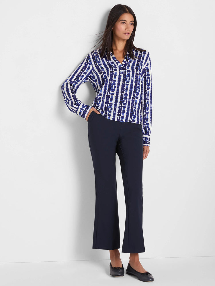 White long-sleeved top with an indigo blue shibori stripe pattern.