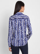 White long-sleeve shibori stripe top with an indigo blue pattern of vertical abstract shapes.