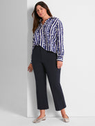 Flowy blue shibori print shirt and dark navy high-waisted straight-leg cropped pants create a chic, professional outfit.