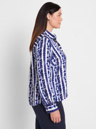 Blue and white collared shirt in a relaxed fit featuring an abstract vertical stripe pattern and long sleeves.