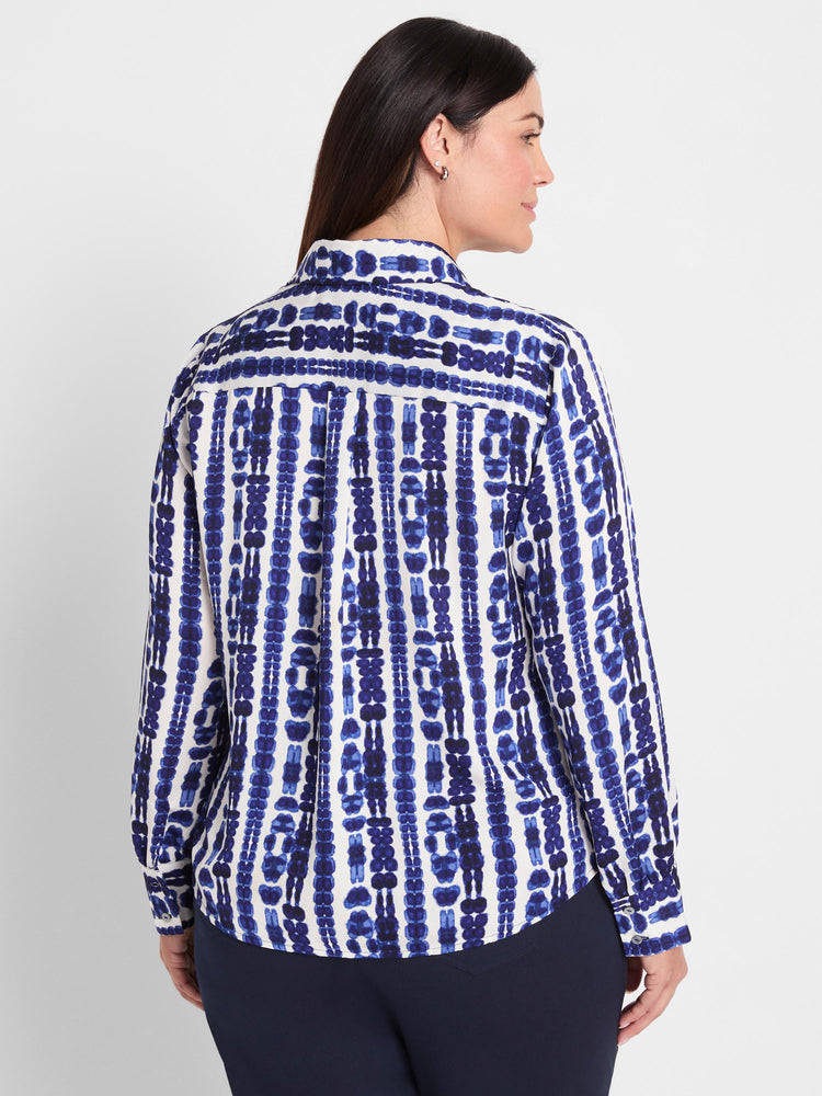 A white long-sleeve button-down shirt with a bold vertical blue tie-dye pattern is worn in a classic fit.