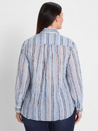 Light blue crinkled shirt with irregular vertical stripes in shades of blue, brown, and black.