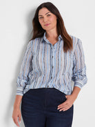 Light blue cotton shirt with painted vertical stripes in shades of blue, tan, and cream.