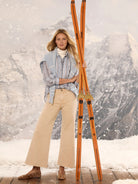 Light blue button-down cotton shirt with painted-style vertical stripes in white, navy, and tan.