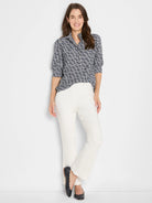 Navy blue button-up shirt with white etched heart pattern and 3/4 length sleeves, worn by a woman.
