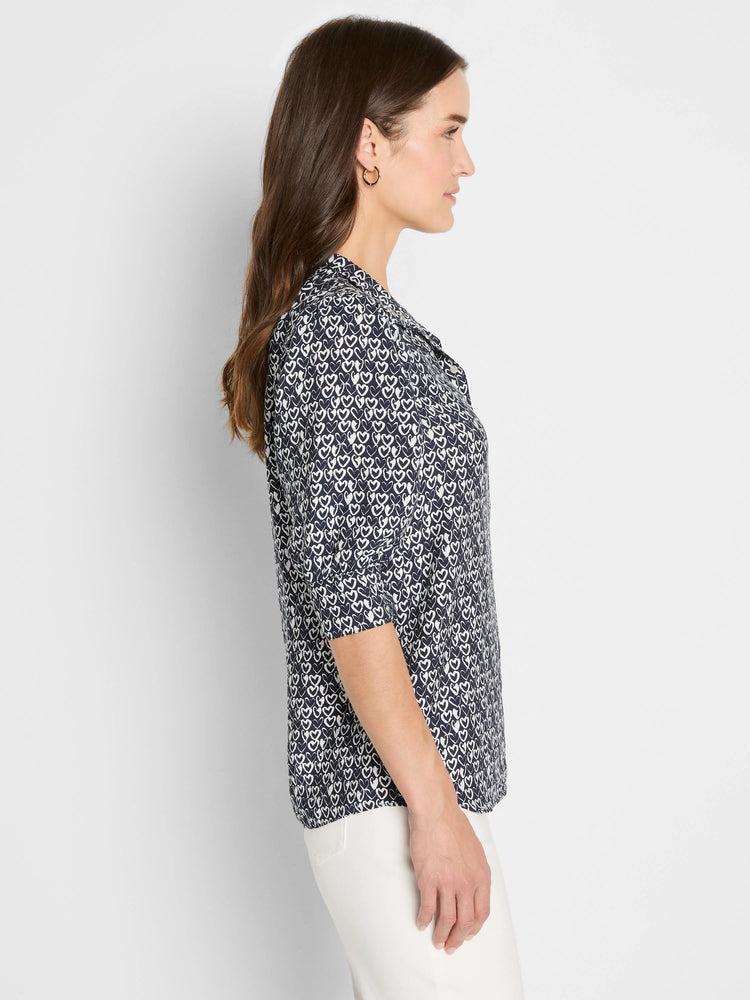 Navy blue shirt with white etched heart pattern, collar, and 3/4 sleeves.