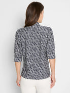Back view of a dark blue shirt with a white etched heart pattern, high collar, and three-quarter sleeves.