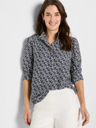 Navy shirt with white etched heart pattern, collared, button-front, and 3/4 sleeves.