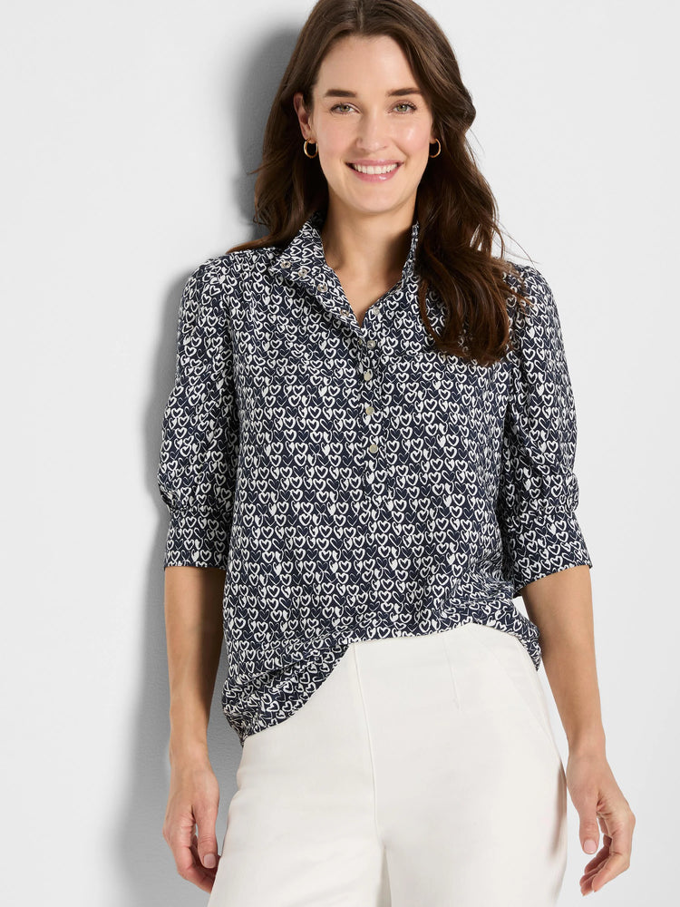 Navy shirt with white etched heart pattern, collared, button-front, and 3/4 sleeves.