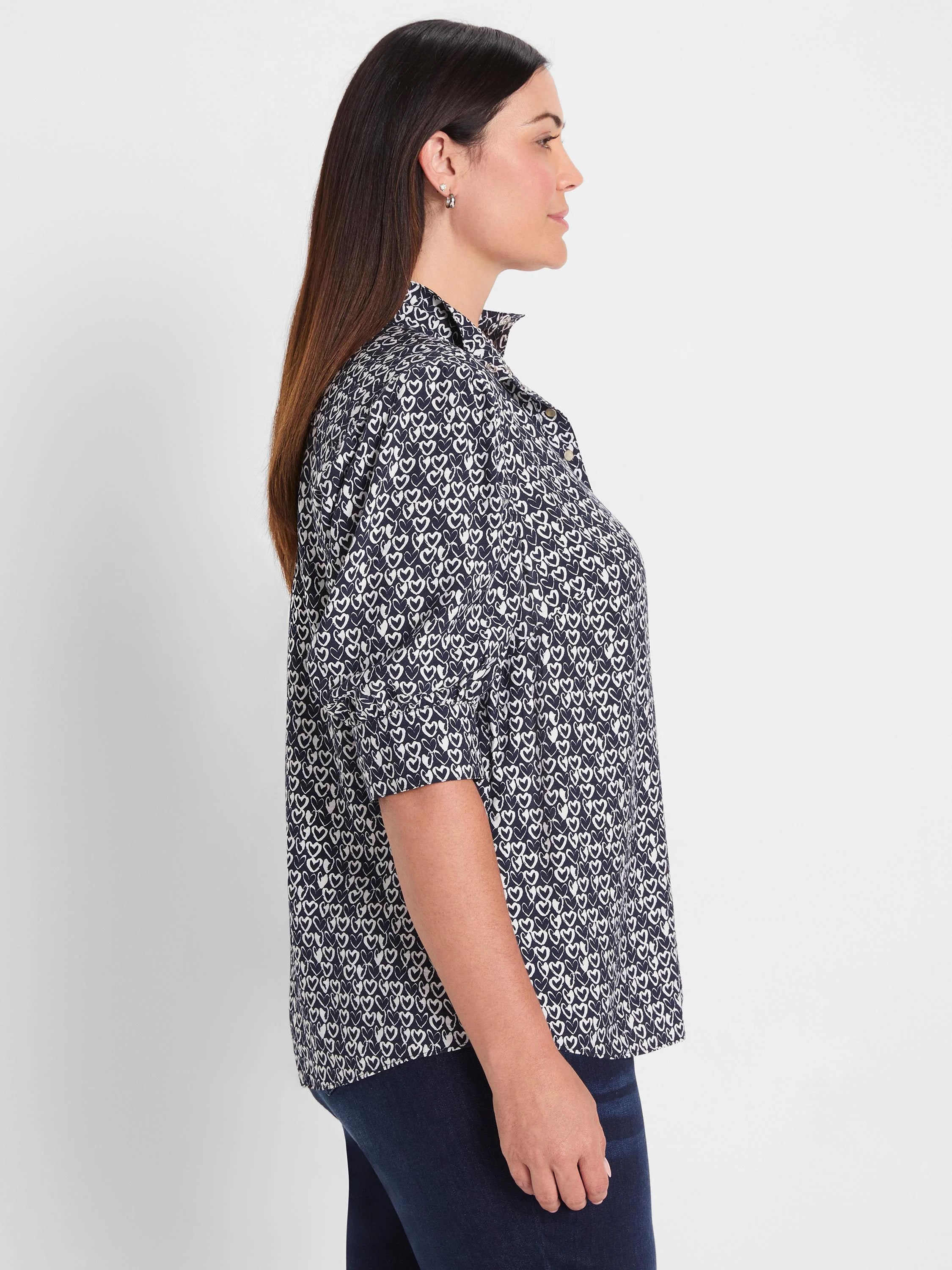 Navy shirt with white etched heart pattern, ruffled stand collar, and 3/4 sleeves.