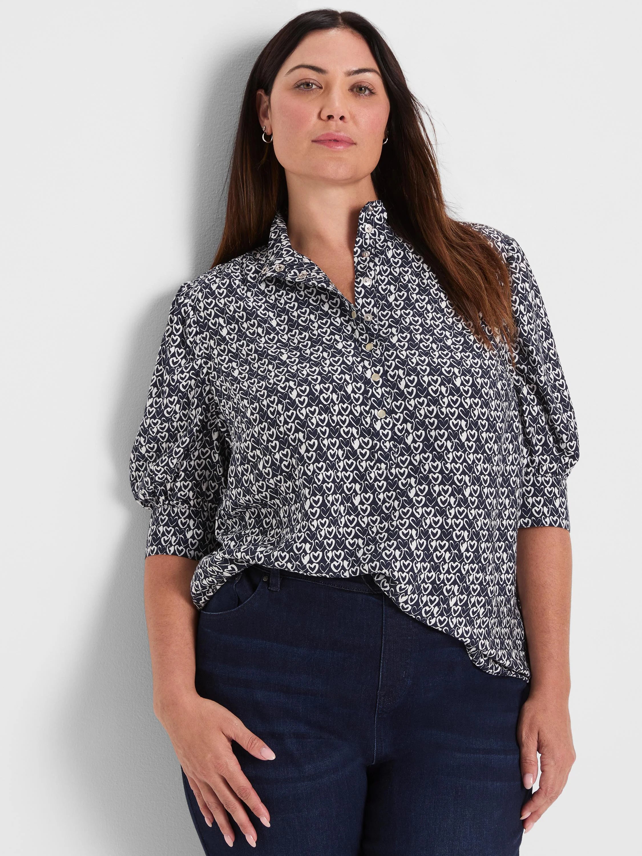 Dark blue collared button-down shirt with small white etched heart pattern and puffed short sleeves.