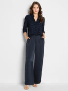 Deep navy blue clipped jacquard top with V-neck, collar, and 3/4 sleeves.