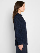 Deep navy blue clipped jacquard top with a textured, fringed surface and stand collar. Long sleeves.