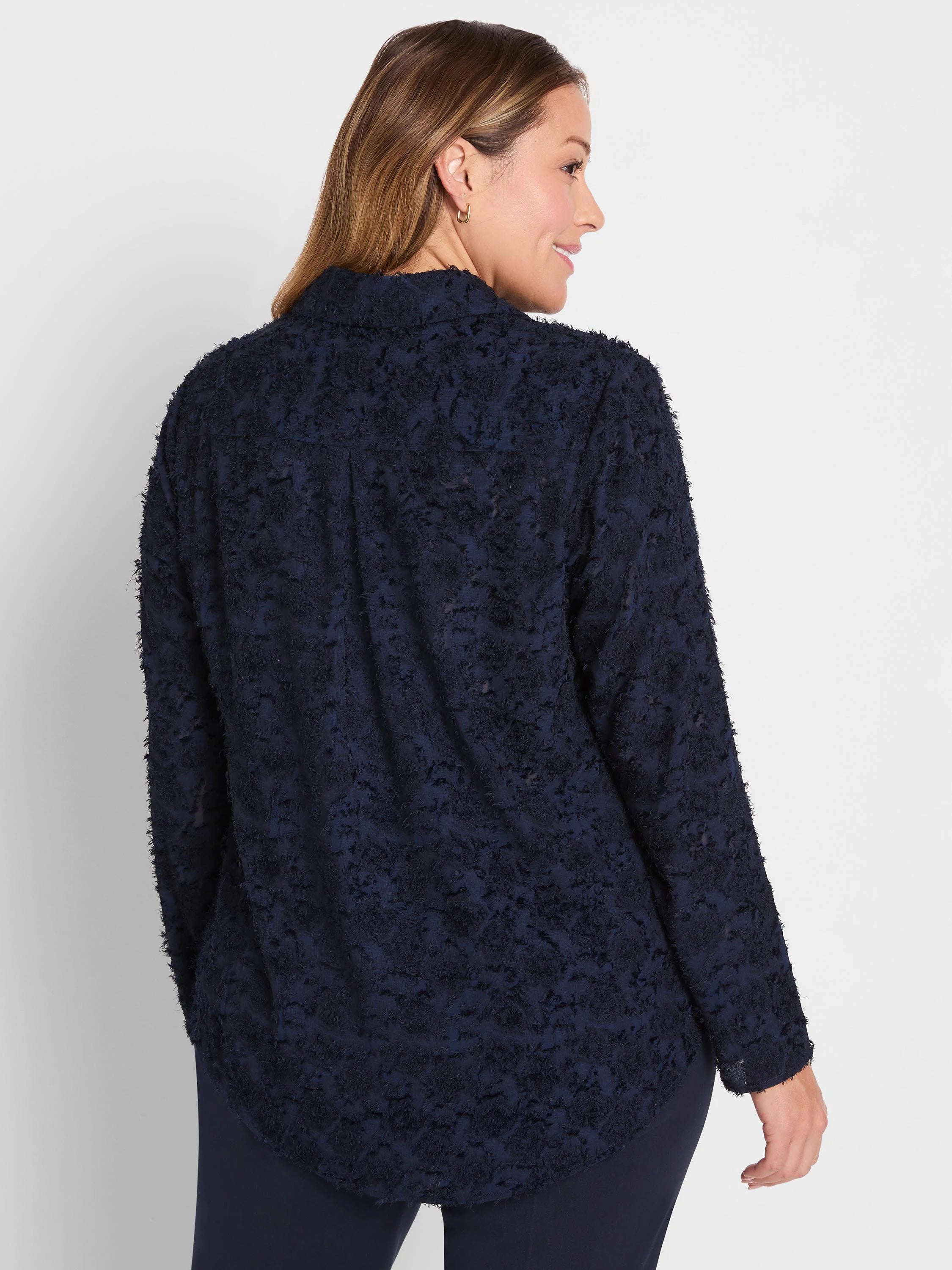 Dark navy long-sleeve top with all-over clipped jacquard texture, creating a raised, fringed pattern.