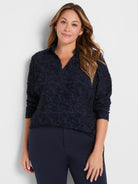 Navy clipped jacquard top with a raised texture, V-neck, collar, and 3/4 sleeves.