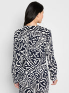 Indigo Leaf Double Crepe Top: Long-sleeved, indigo with an abstract white leaf pattern and button cuffs.