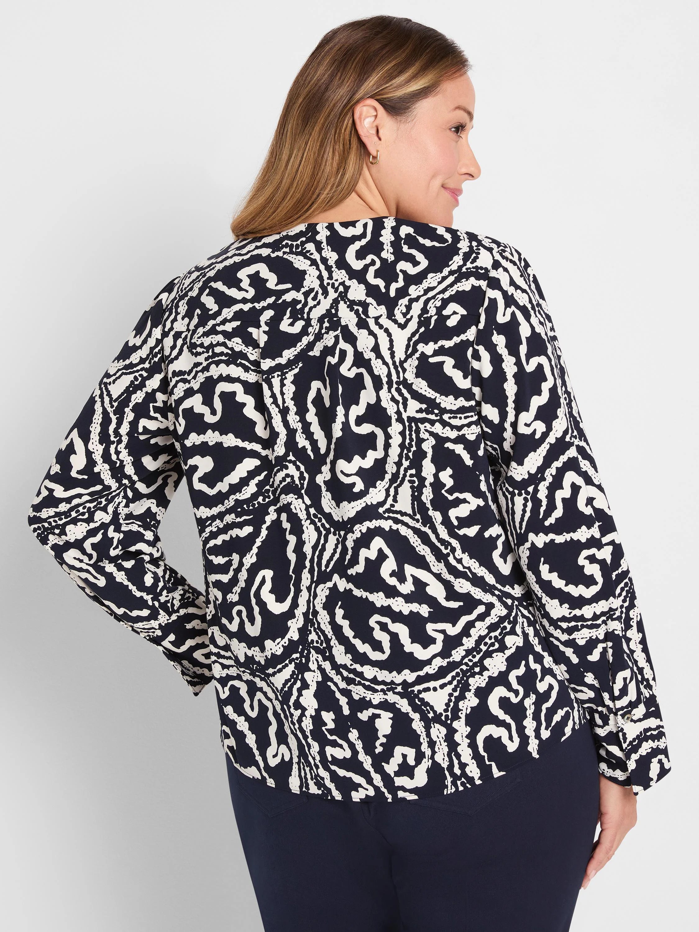 Dark indigo long-sleeved top with an off-white abstract organic pattern.