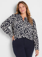 Indigo top with white abstract leaf pattern, featuring a V-neck and long sleeves.