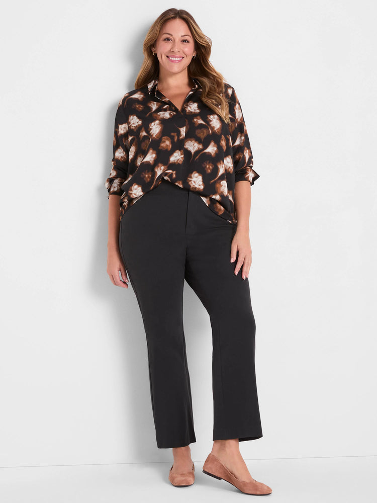 Dark brown popover shirt with golden ginko leaf print. Collared, long sleeves rolled.
