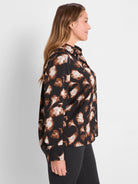 Dark popover shirt with brown & cream ginkgo leaf pattern, long sleeves & collar.