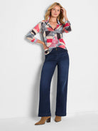 Crinkled cotton button-down shirt with a multi-color geometric pattern in red, blue, black, and beige. Long sleeves.