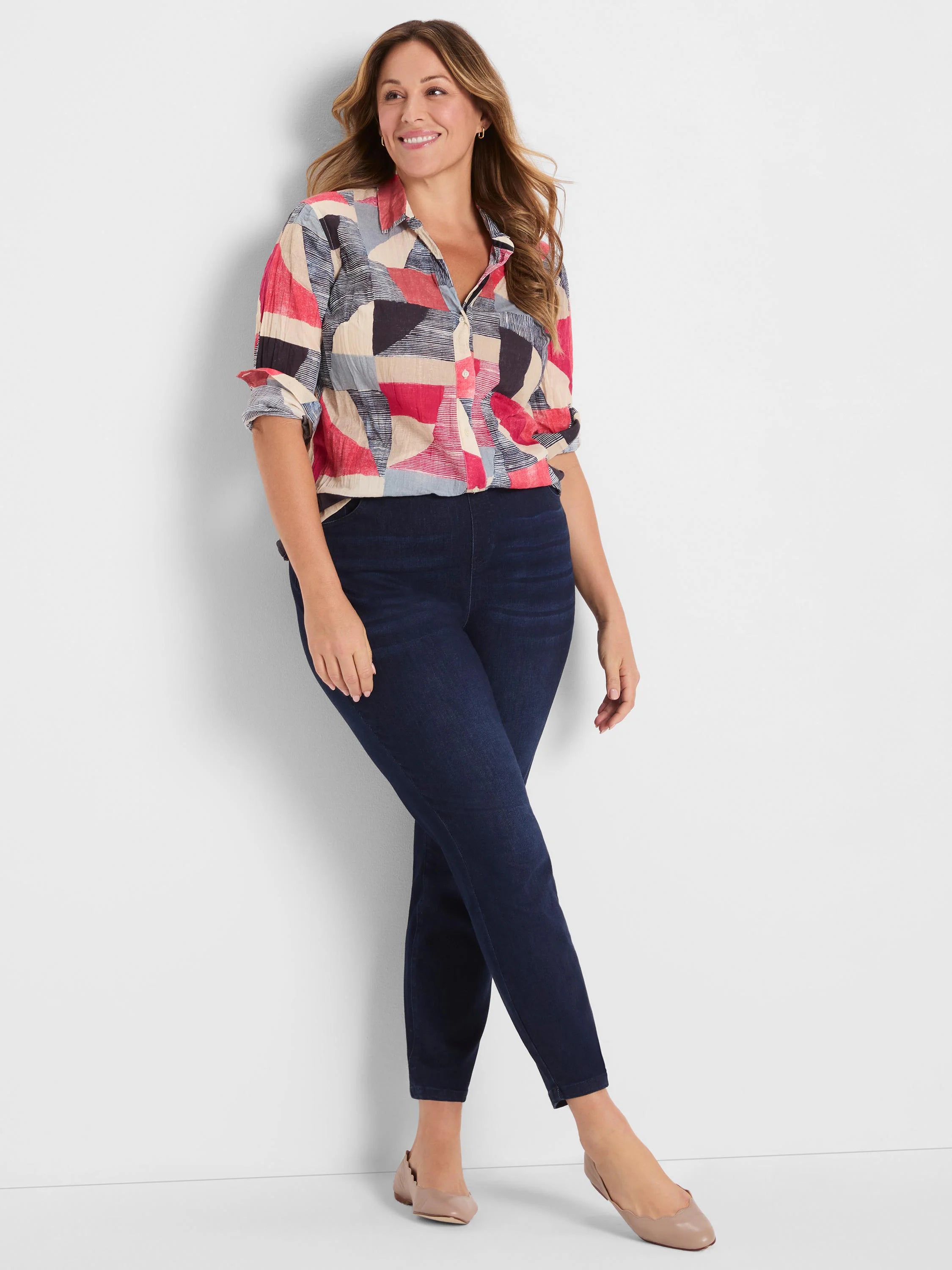 Crinkle button-down shirt with geometric pattern in red, navy, beige, slate blue, & black. Sleeves rolled.