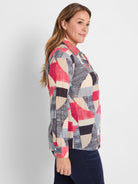 Crinkle cotton shirt with an abstract geometric patchwork pattern in red, blue, tan, and black.