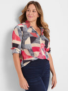 Crinkle shirt with geometric pattern: red, navy, beige, light blue blocks & stripes. Collared, button-up, rolled sleeves.