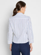 A tailored white blouse with vertical blue and grey stripes features three-quarter length sleeves cuffed at the forearm.
