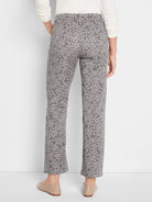 Dark taupe straight ankle jeans with light grey leopard print, visible from behind.