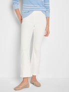 Cream bootcut jeans with a smooth texture, gently flared from the knee to above the ankle.