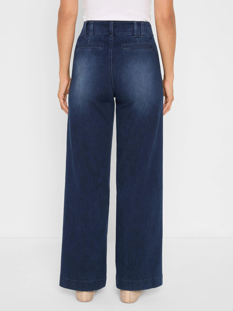 Dark wash wide-leg trouser jeans with belt loops and two horizontal back pockets, shown from behind on a model.