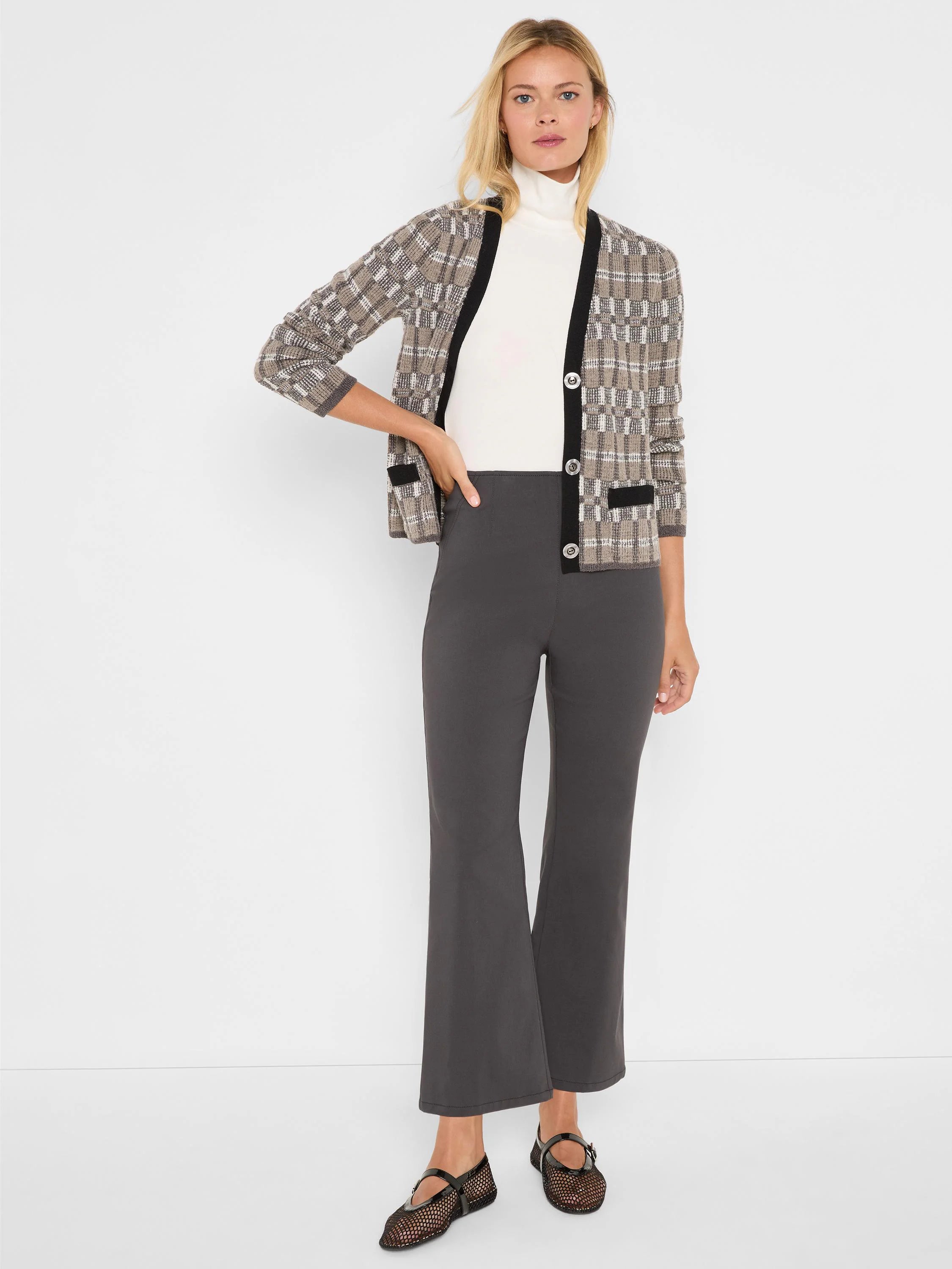 Dark gray bootcut pants, fitted through the hip and thigh, with a subtle flare at ankle length.