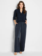 Dark navy, glossy wide-leg pull-on pants with an elastic waist and pockets.