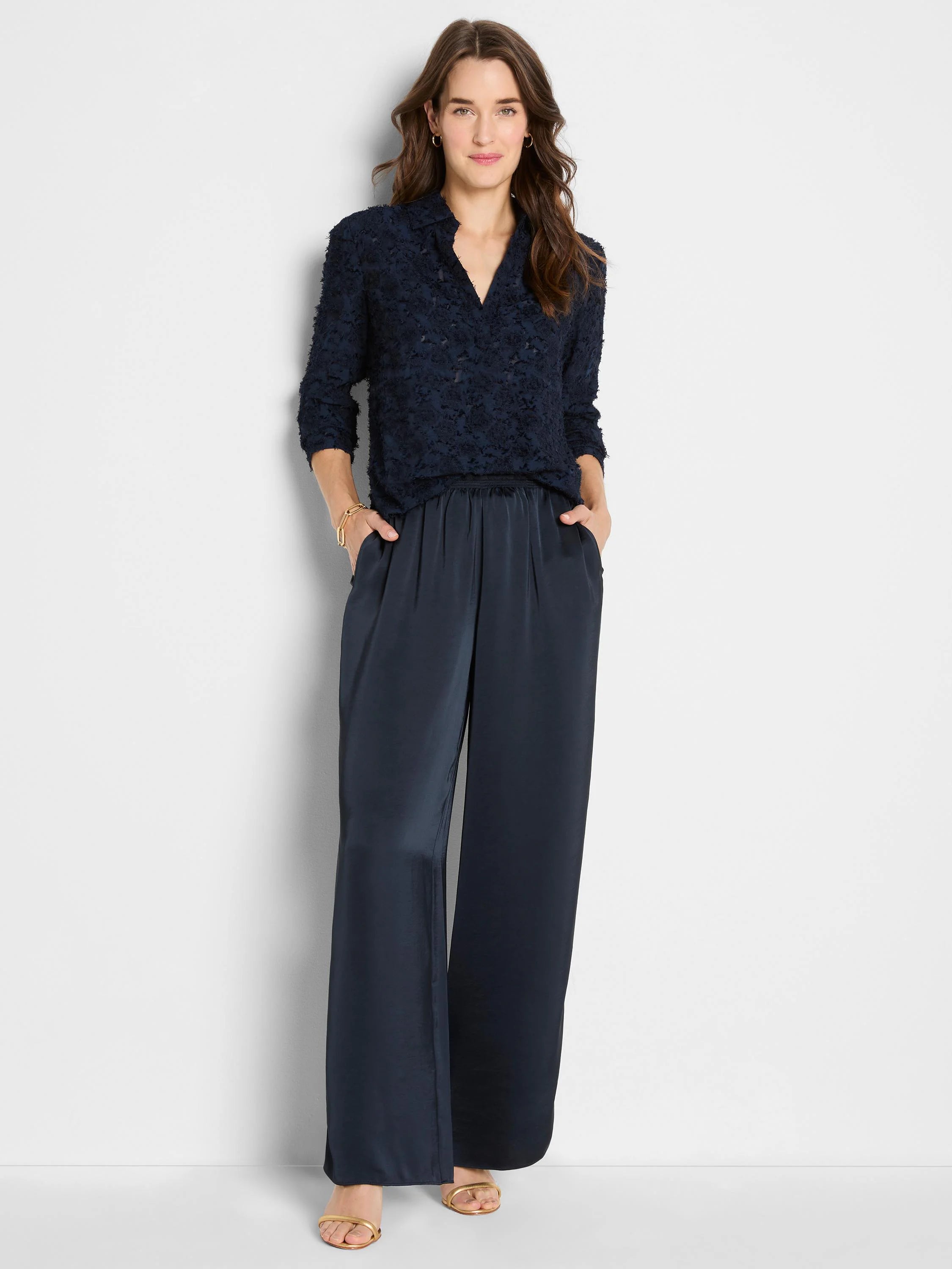 Dark navy, glossy wide-leg pull-on pants with an elastic waist and pockets.