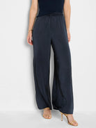 Dark blue, glossy wide-leg pull-on pants with an elastic waistband.